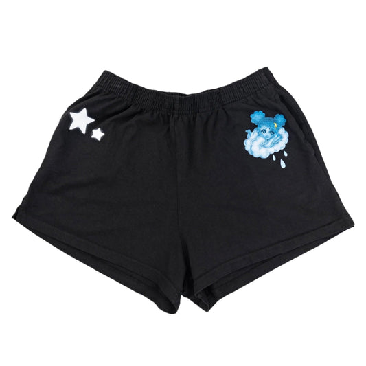 Black shorts with cloud and star designs on a white background